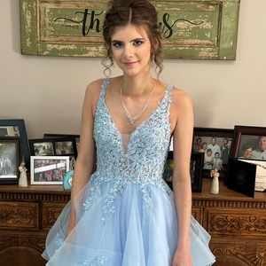 Beautiful light blue prom dress. It is a size 4 and has not been altered.